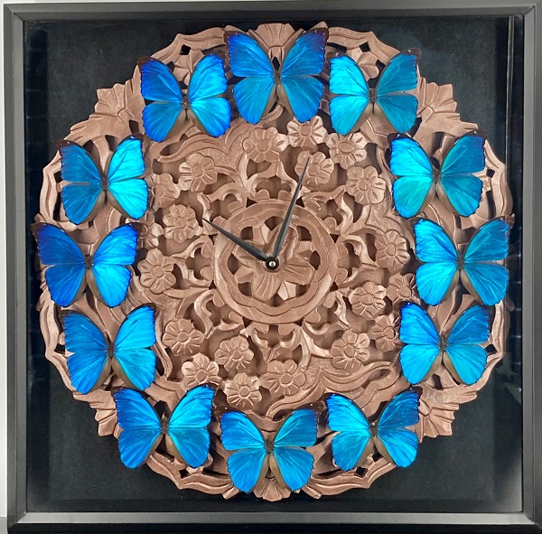 shimmering blue butterflies arranged on a wooden clock